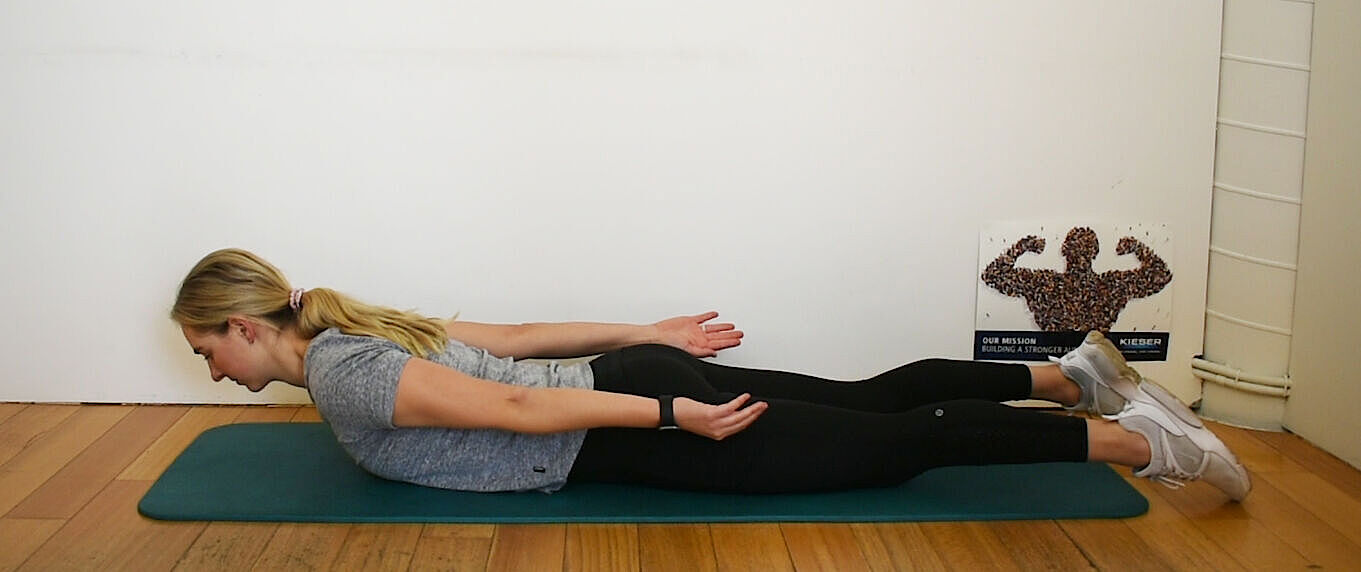 Demonstrating F3 - Prone lumbar extension exercise